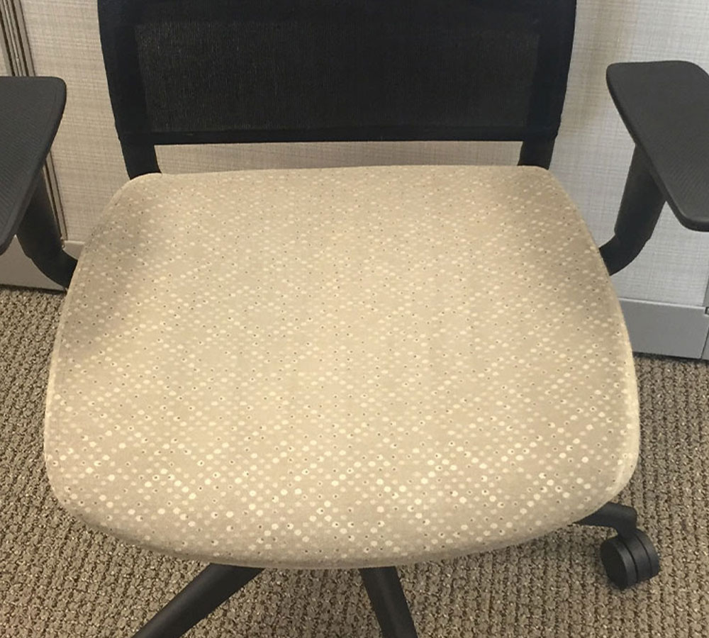 dpm-surface-care-furniture-fabric-panels-after A white office chair with a removed stain on the seat, after cleaning. Furniture and fabric panel. DPM Surface Care