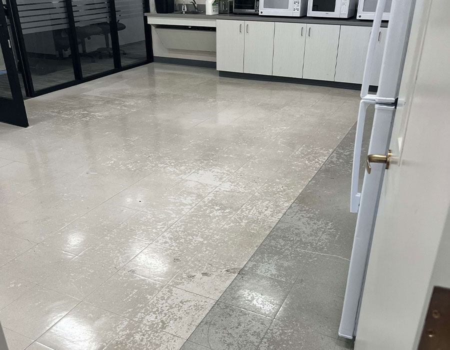 dpm-surface-care-resilient-flooring-before A tiled resilient flooring in a commercial office pantry, completely faded and worn out, before cleaning and coating. DPM Surface Care
