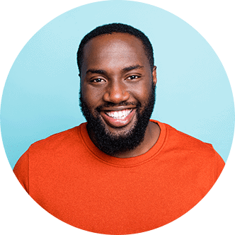 Charming black man smiling against colored background | Armin Dental Associates