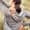 Rearview shot of a woman experiencing back pain while working out in nature