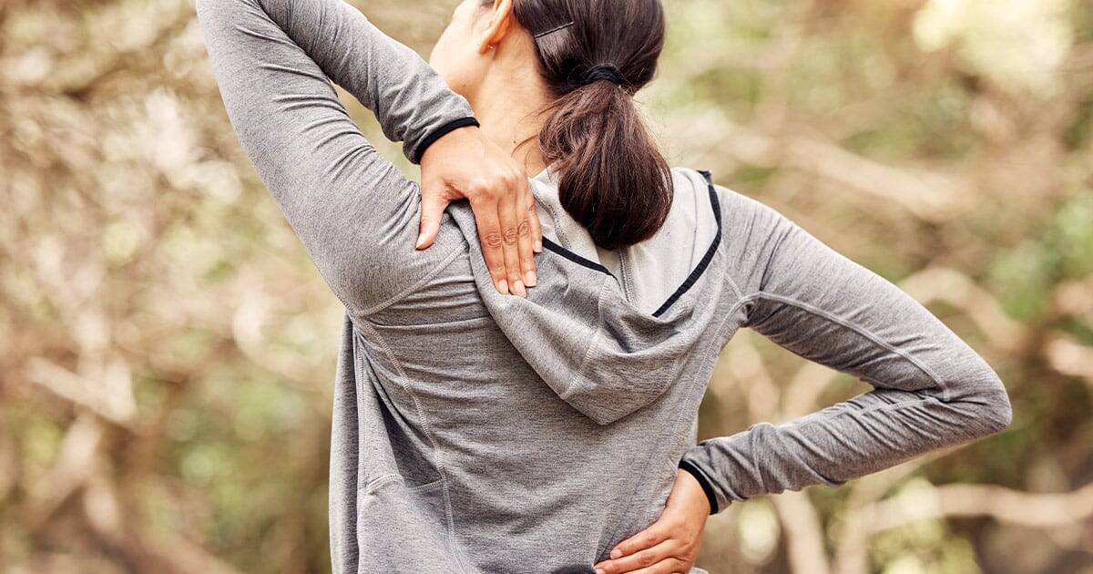 Stretches for shoulder and back pain relief outdoors in casual sportswear.