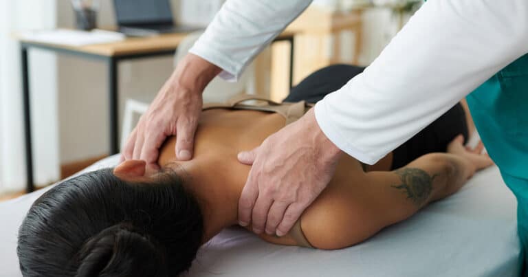 Back pain chiropractic adjustment by Dr. Rebecca-Jane McAllister at her health clinic.