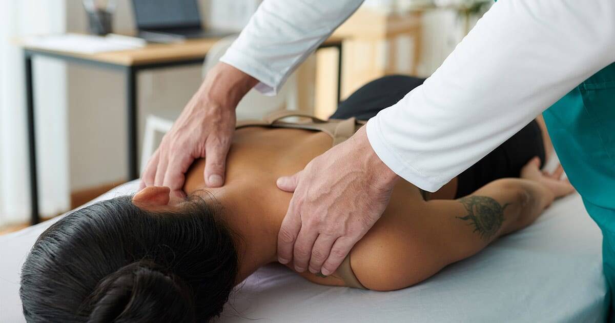 Back pain chiropractic adjustment by Dr. Rebecca-Jane McAllister at her health clinic.