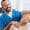 portrait of smiling chiropractor stretching neck