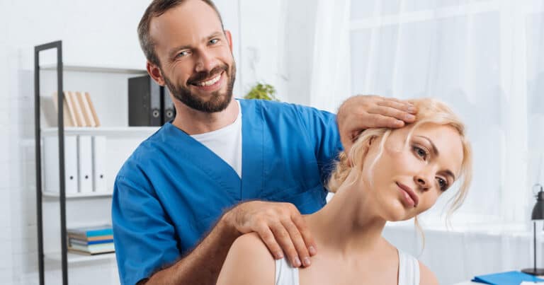 Relief chiropractor performing neck adjustment on female patient in modern clinic setting.
