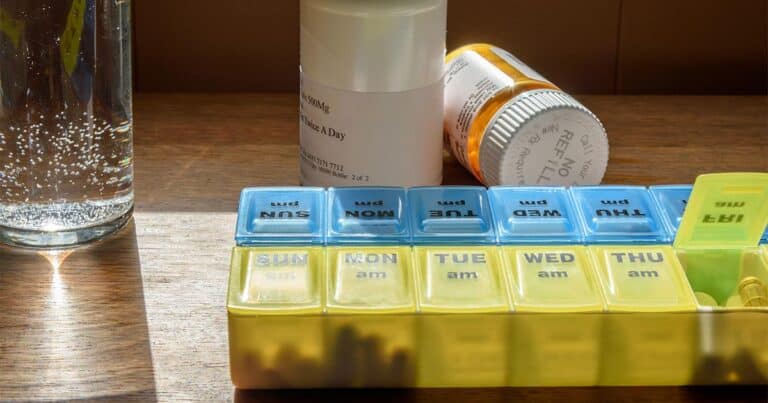 Medication management and weekly pill organizer for health review.