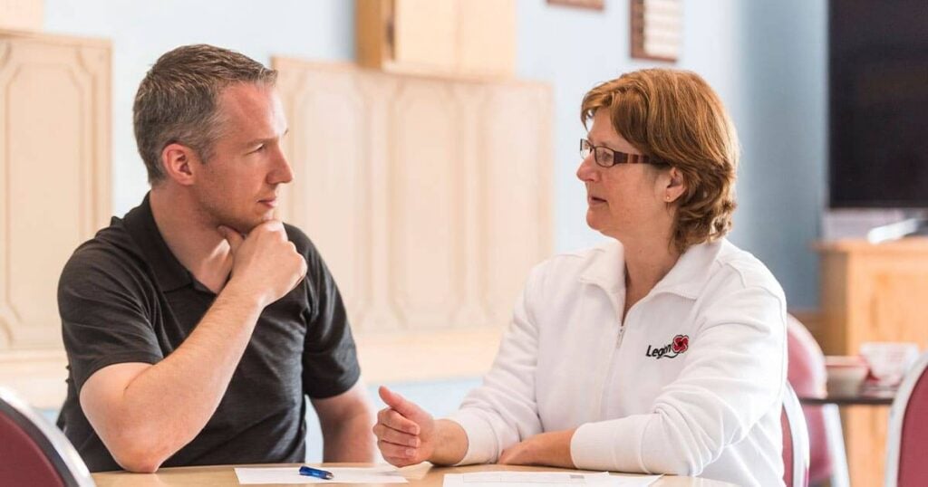 Veteran discussing disability benefits with a caseworker.