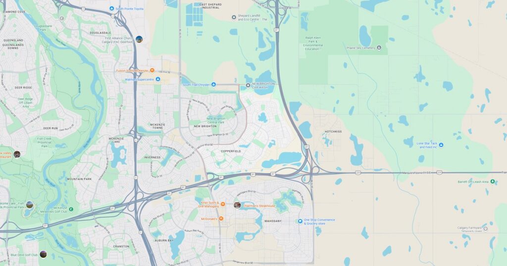 Map of suburban city with roads, lakes, and parks at sunset.