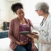 Pregnant woman with doctor in a consultation, healthcare, prenatal care, obstetrics, gynecology.