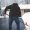 Man shoveling snow on his driveway in the winter
