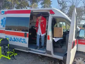 Emergency medical technician preparing inside ambulance at Merosina health center.