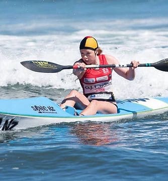 Young surf lifesaver paddling on a kayak at East End Surf Life Saving Club, NZ.