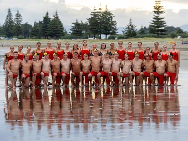 Competitive surf lifesavers group photo at East End Surf Life Saving Club, New Zealand.