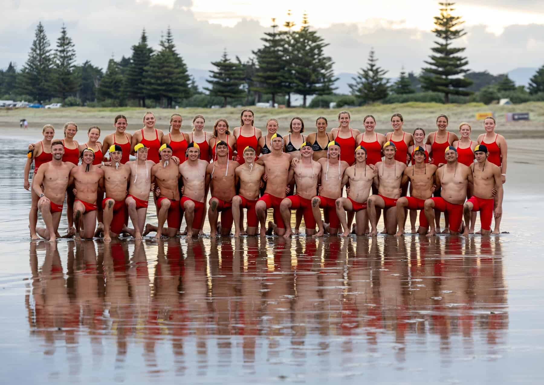 Competitive surf lifesavers group photo at East End Surf Life Saving Club, New Zealand.