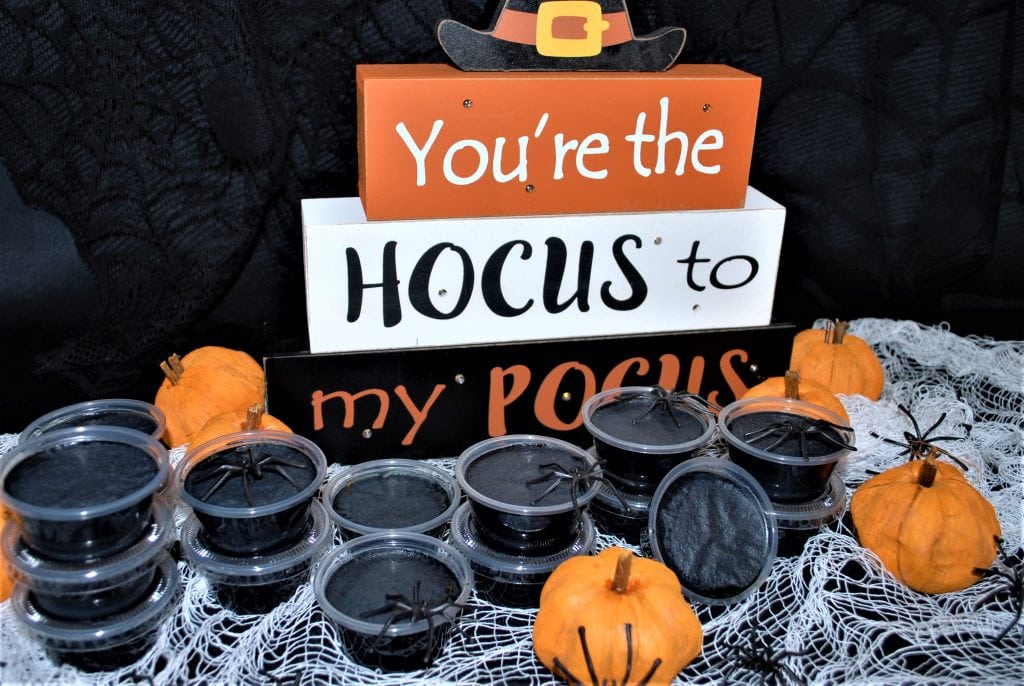 Coconut Halloween Jello Shots served on creepy cloth with spiders and mini pumpkins
