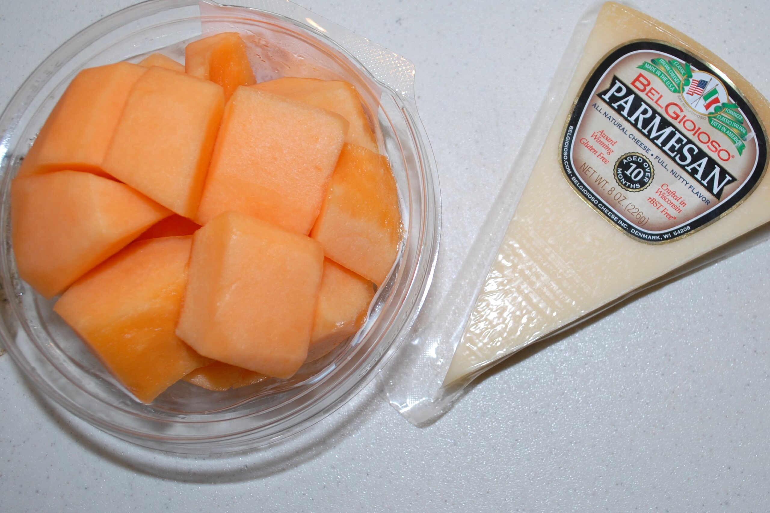 Cantaloupe chunks and a piece of parmesan cheese
