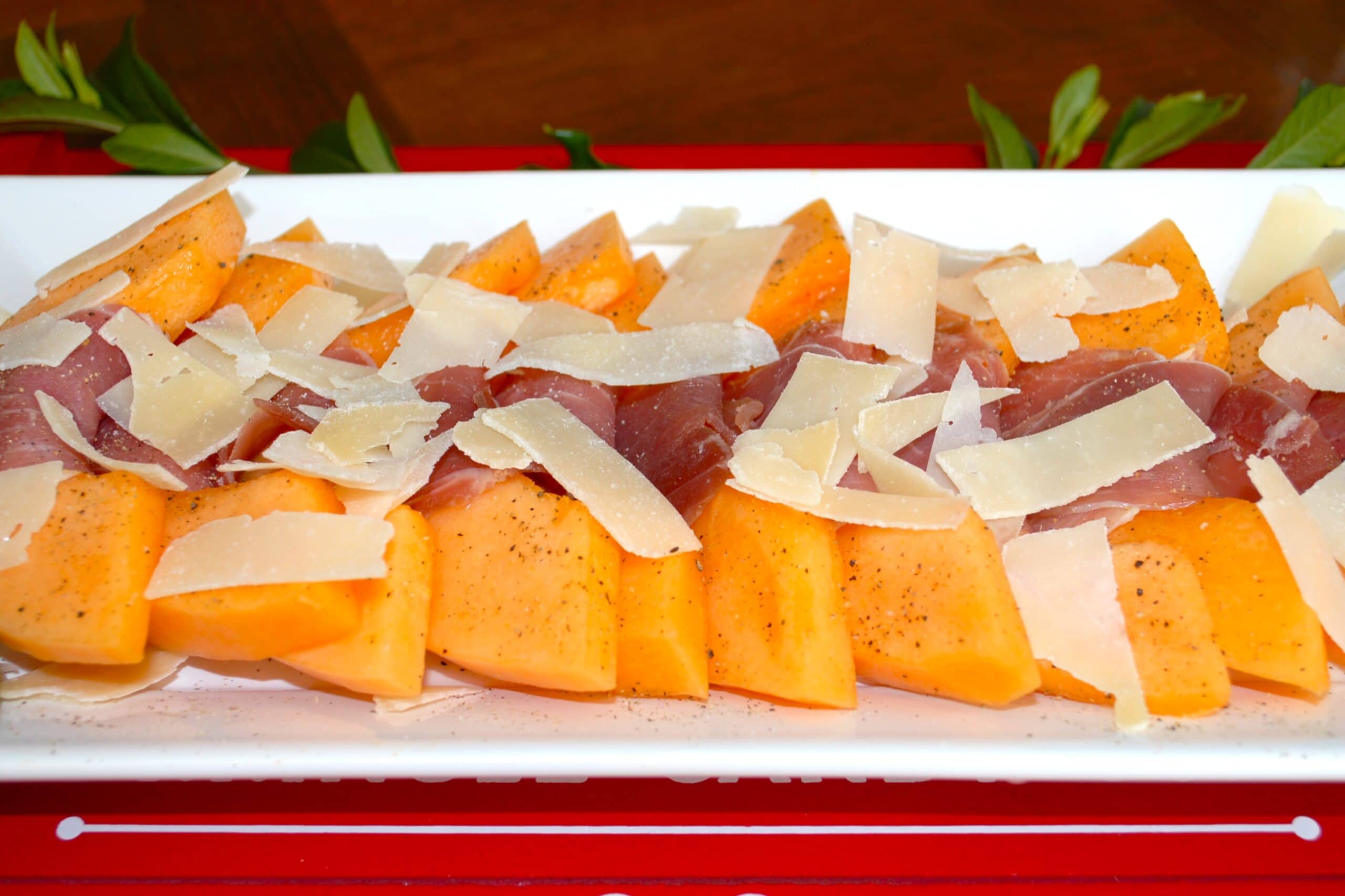 Melon Wrapped with Prosciutto and sprinkled with shaved parmesan