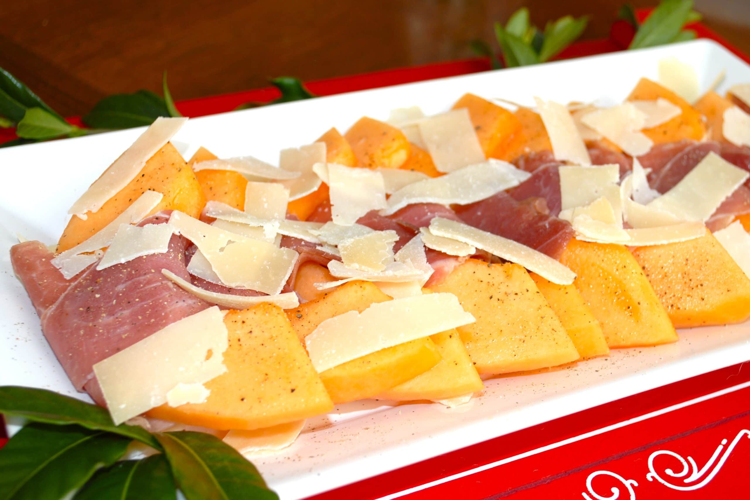 Melon Wrapped with Prosciutto and sprinkled with shaved parmesan