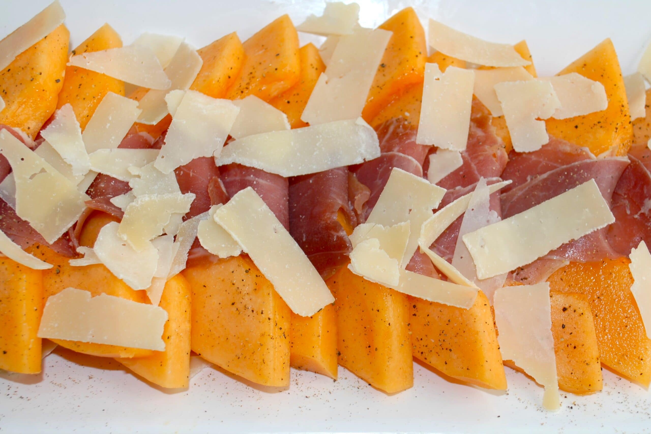 Melon Wrapped with Prosciutto and sprinkled with shaved parmesan