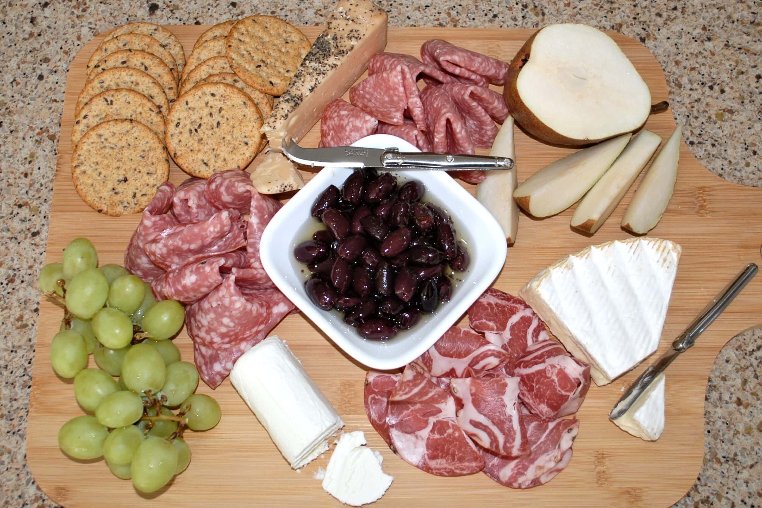 Charcuterie Board with olives, cheeses, meats, and fruit