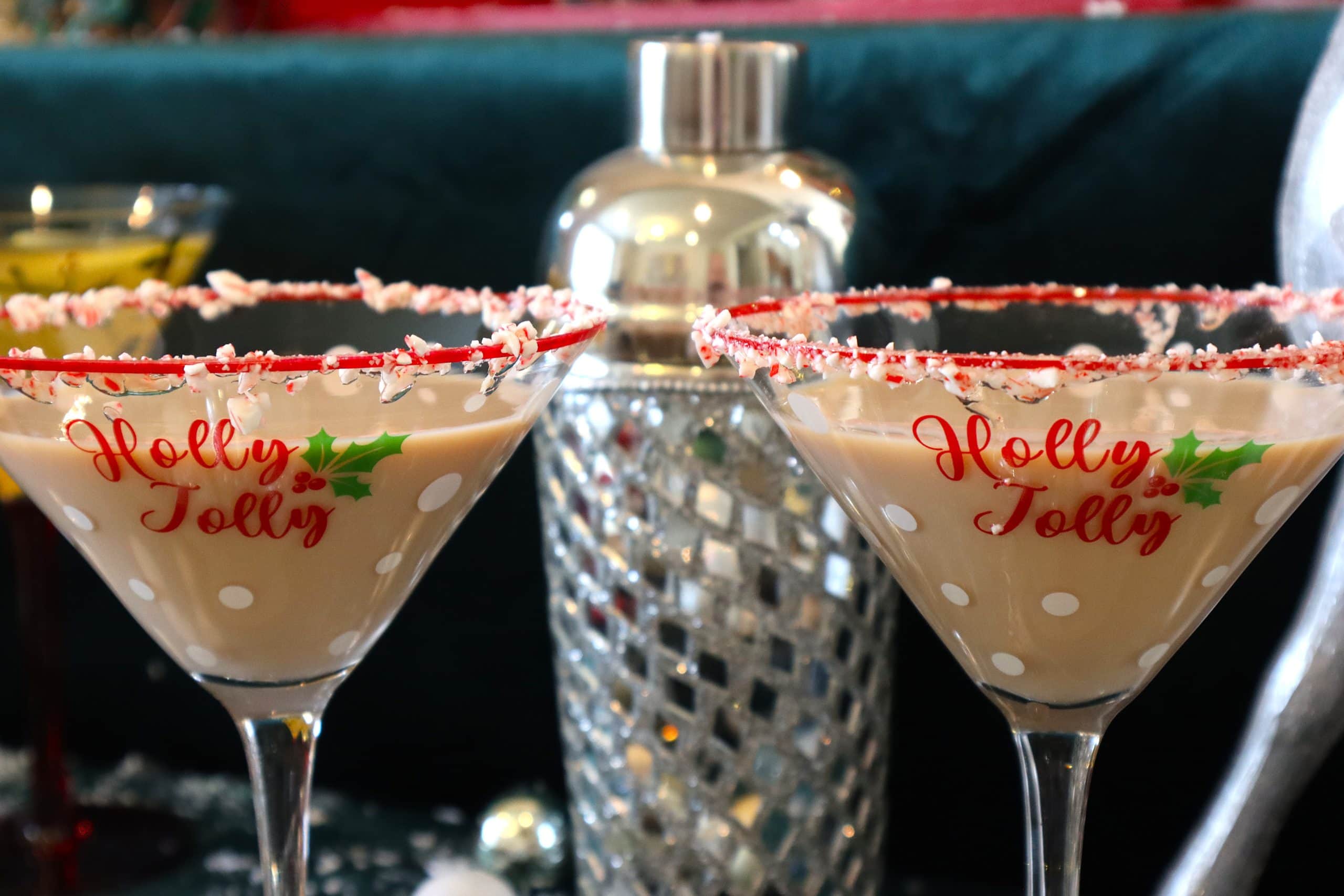 Two RumChata Peppermint Bark Martinis rimmed in crushed candy canes