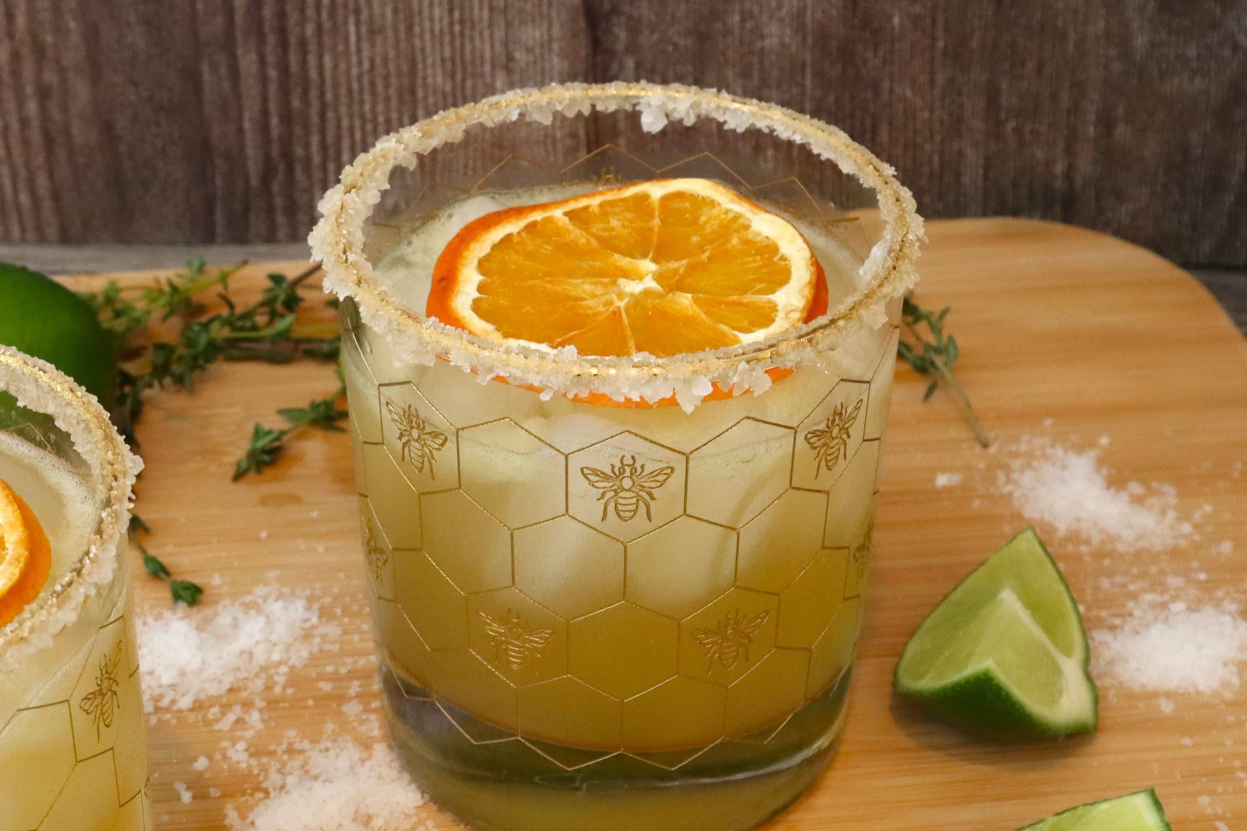 A Bitter Orange Margarita with a dehydrated orange slice