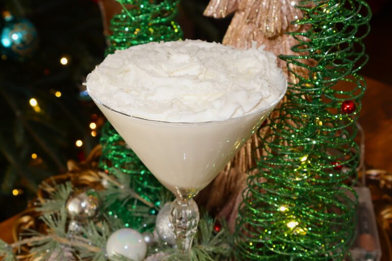 Snowball Martini Garnished with Whipped Cream and Coconut Flakes