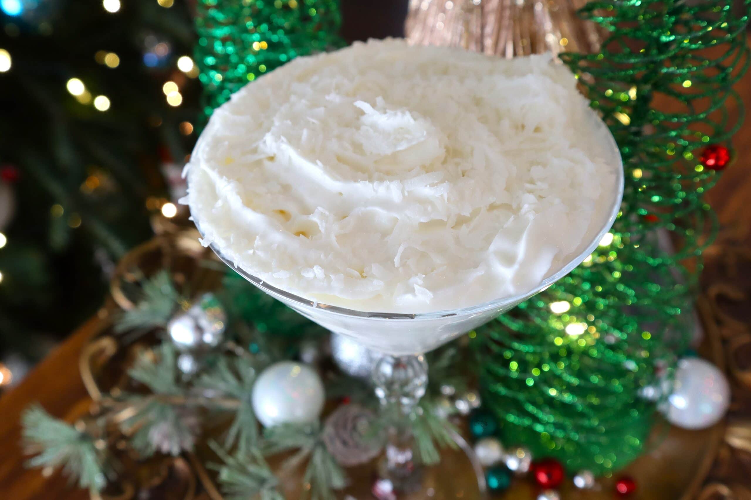 Snowball Martini Garnished with Whipped Cream and Coconut Flakes