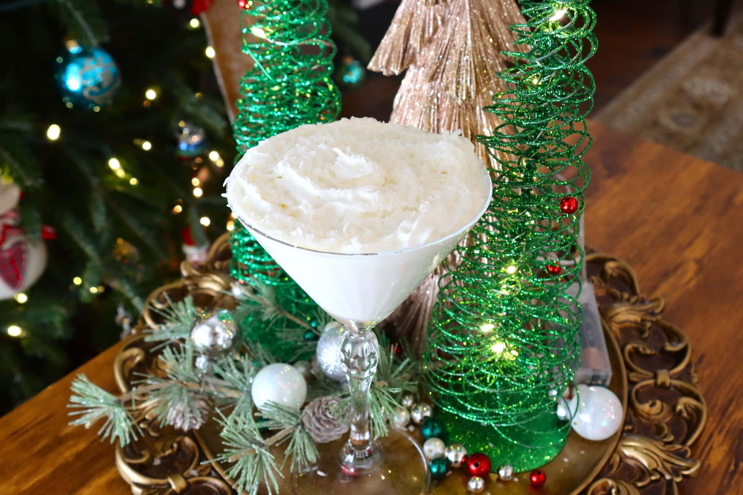 Snowball Martini Garnished with Whipped Cream and Coconut Flakes