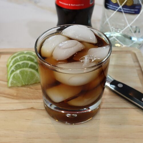 Rum and Coke with limes on the side