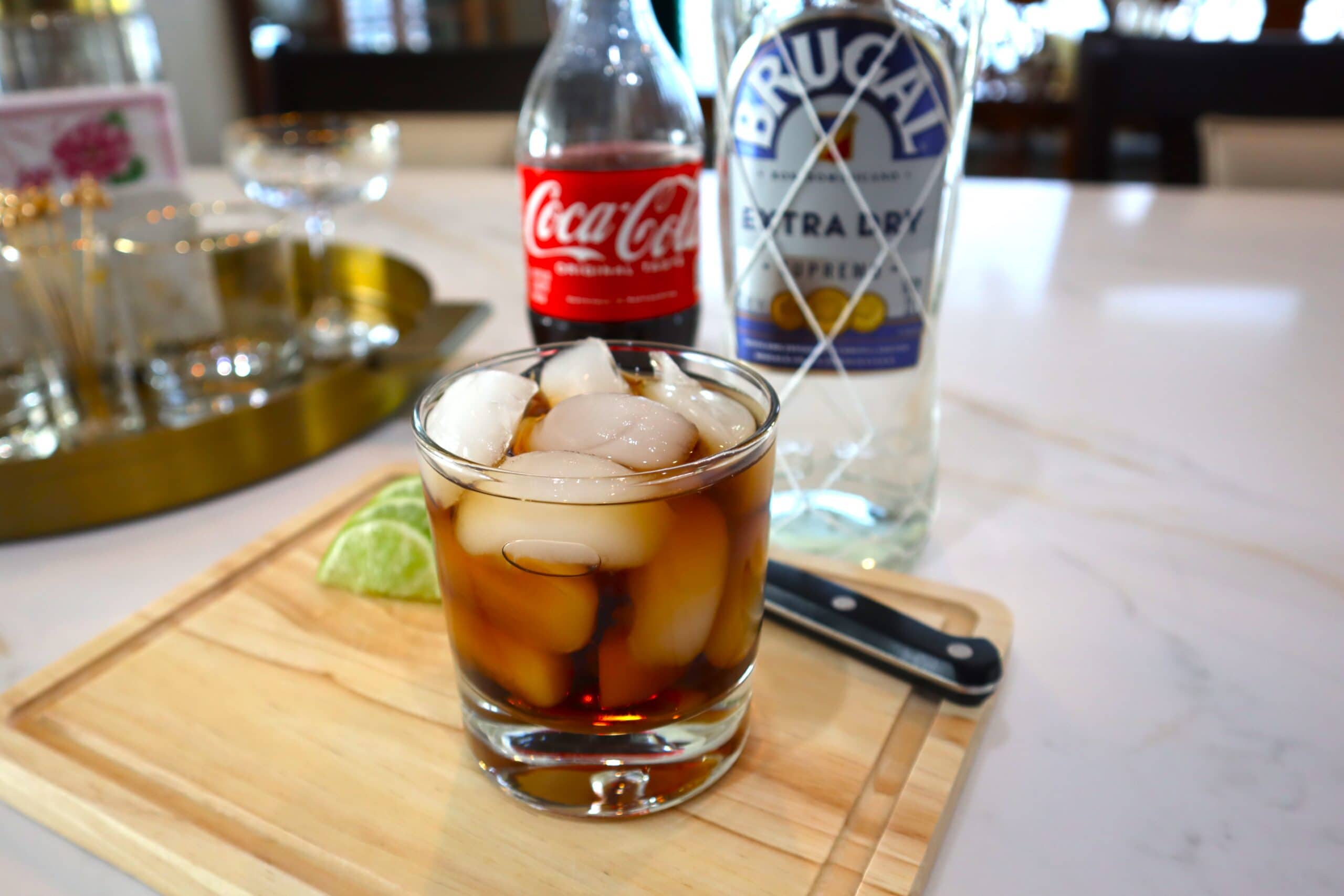 Rum and Coke with limes on the side
