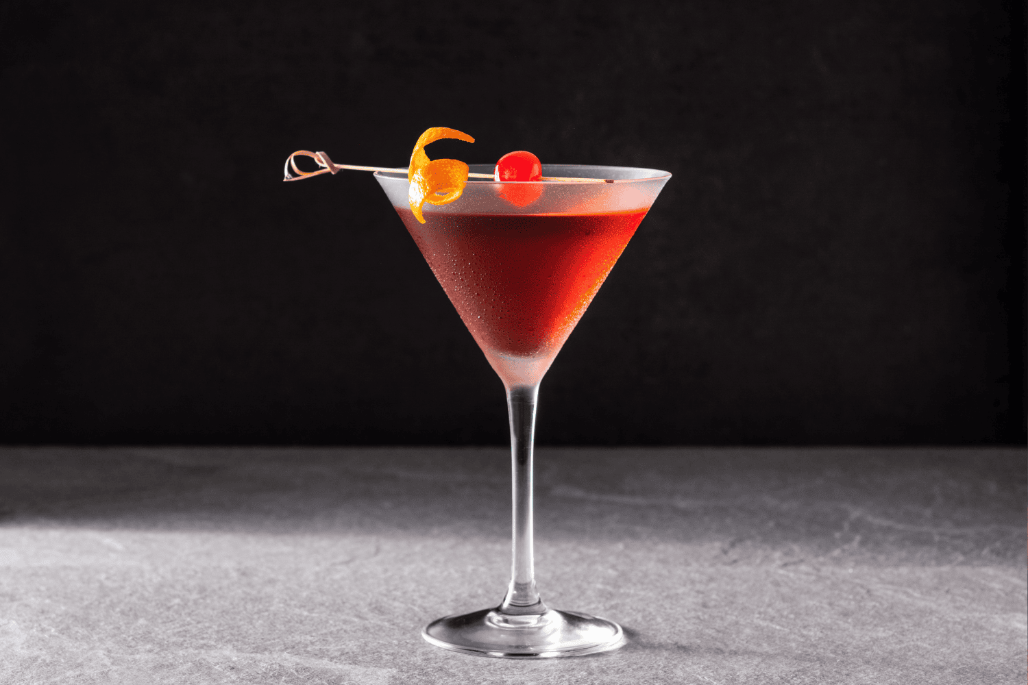 Manhattan with an orange twist and cherry
