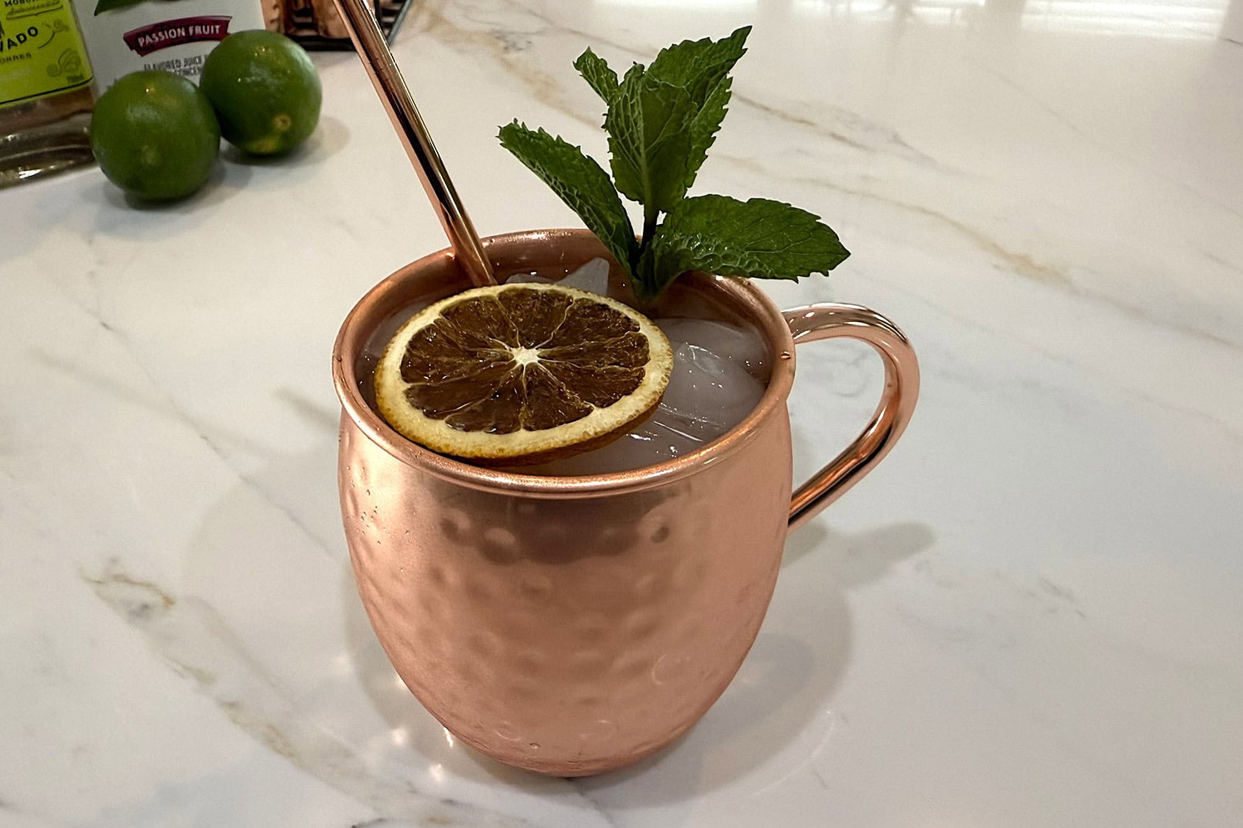 Lima Mule garnished with a mint sprig and dehydrated orange slice