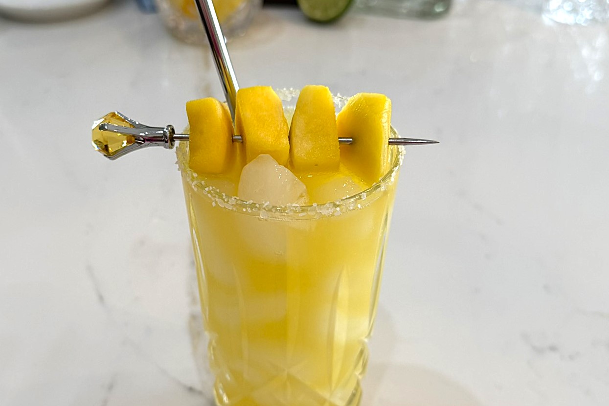 Mango Margarita garnished with chunks of mango