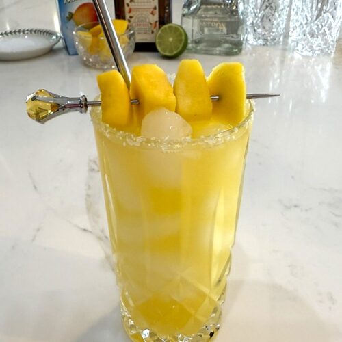 Mango Margarita garnished with chunks of mango