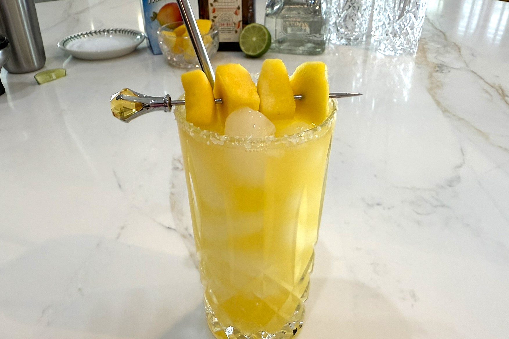 Mango Margarita garnished with chunks of mango