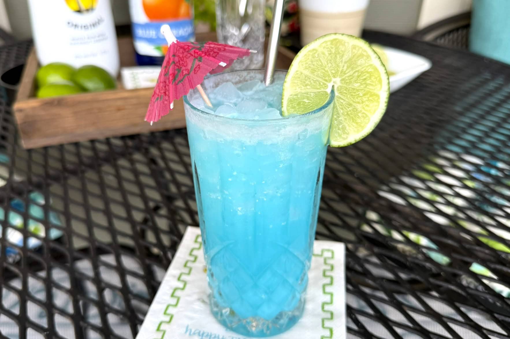 The Rum Ice Breaker with a slice of lime and pink umbrella