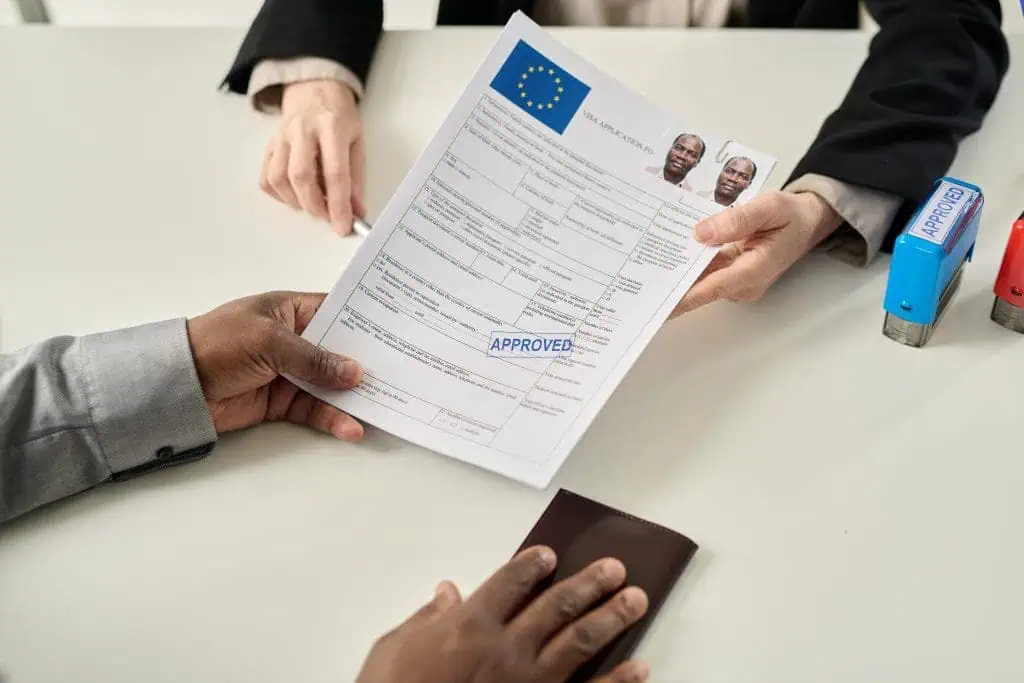 top view of black man holding approved visa 2022 12 07 01 15 48 utc