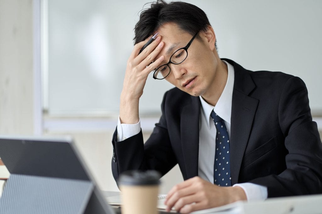 worried asian businessman holding his head 2023 03 01 22 40 02 utc min
