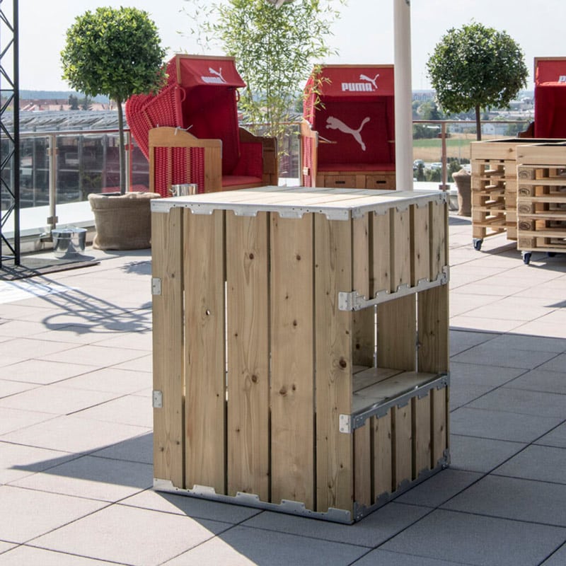 Wooden storage crate with metal fittings on terrace.