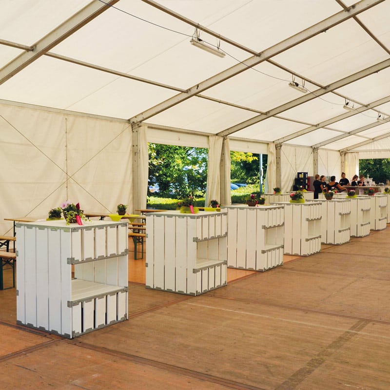 Portable event bar stations at outdoor reception tent.
