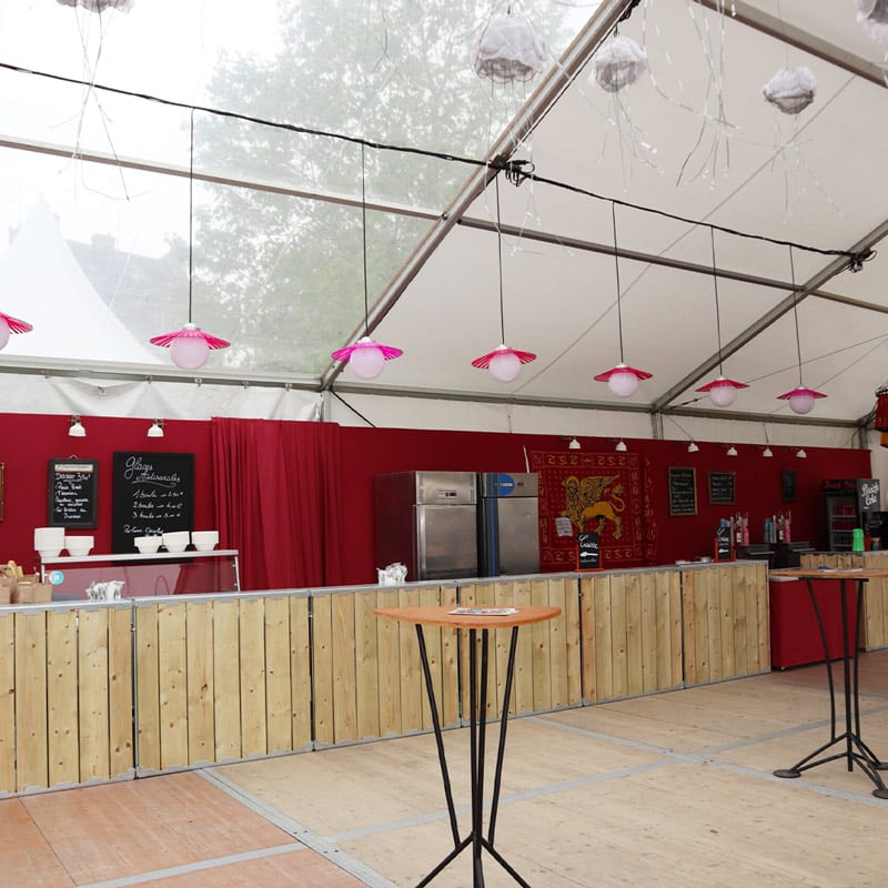 EJH Distribution event catering setup with red decor and hanging pink lamps.