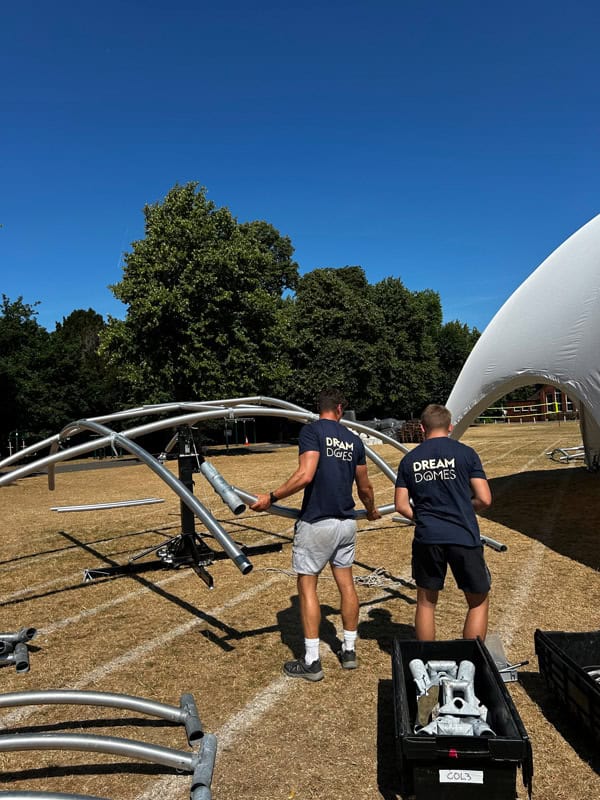 two men holding metal pipes