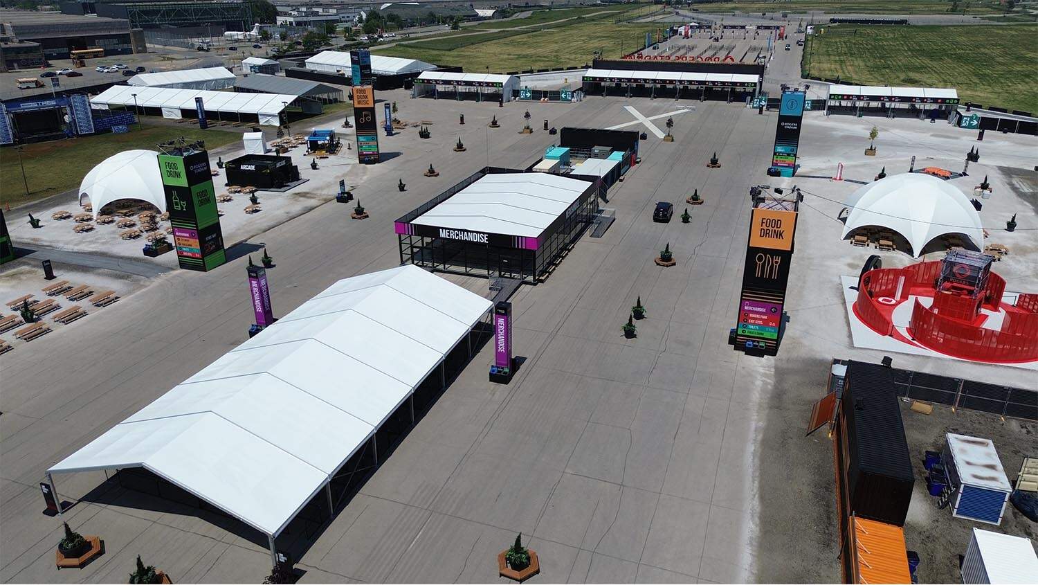 Outdoor event space with tents, signage, and food/drink stations showcasing EJH Distribution logistics and warehousing solutions.