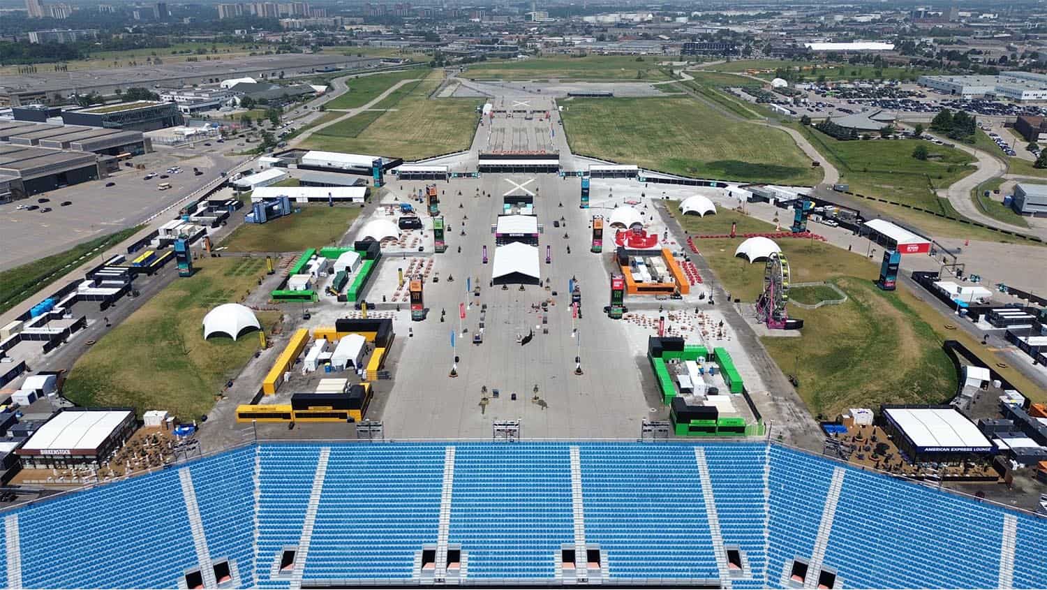 Modern outdoor event setup space with multiple colorful booths, tents, and attractions for an expo or festival, emphasizing logistics and distribution capabilities of EJH Distribution.