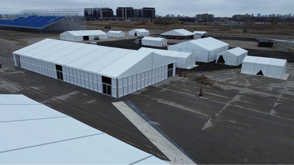 Temporary event tents setup for logistics and storage solutions by EJH Distribution at an industrial site.