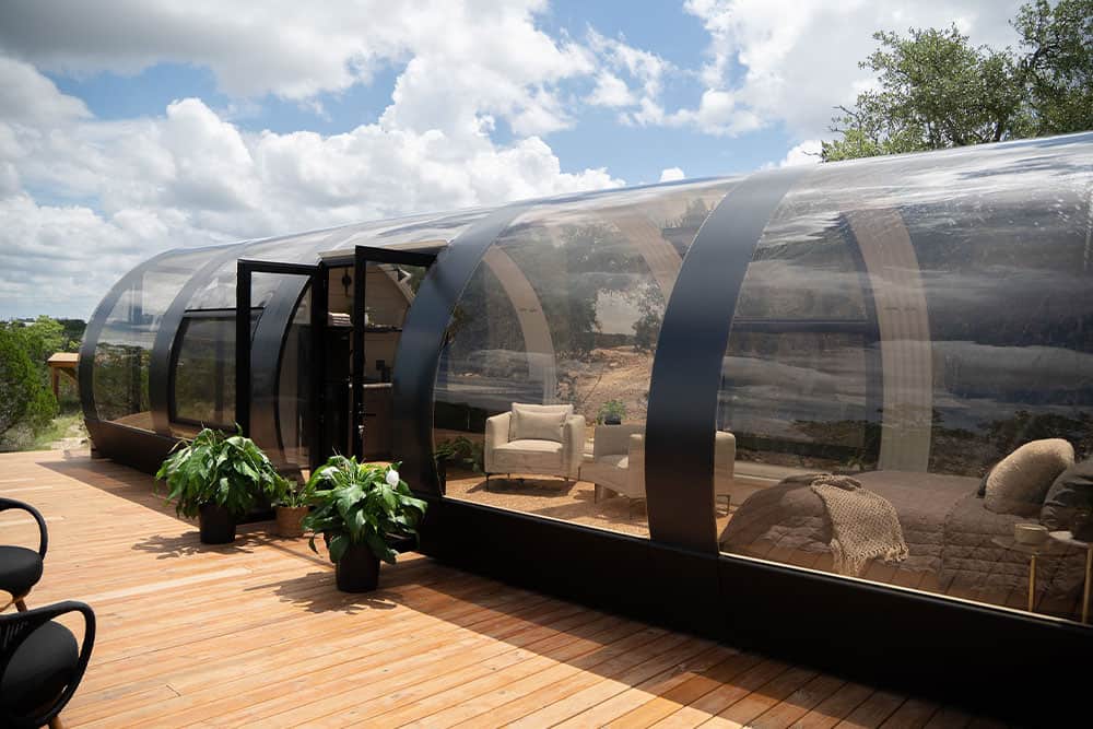 Polycarbonate outdoor living pod, modern transparent enclosure, outdoor living space, stylish sunroom, contemporary patio design, durable weatherproof structure, innovative outdoor architecture, premium outdoor pod for relaxation or entertainment, stylish backyard enclosure, high-quality outdoor living solution.