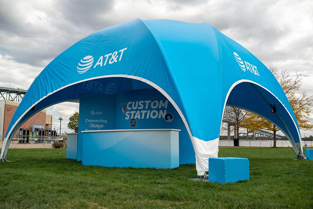Blue AT&T branded event tent with custom station setup, outdoor promotional display, and portable canopy for branding at public events and outdoor gatherings.
