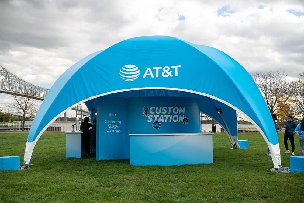 AT&T branded temporary outdoor event tent in blue with custom branding.