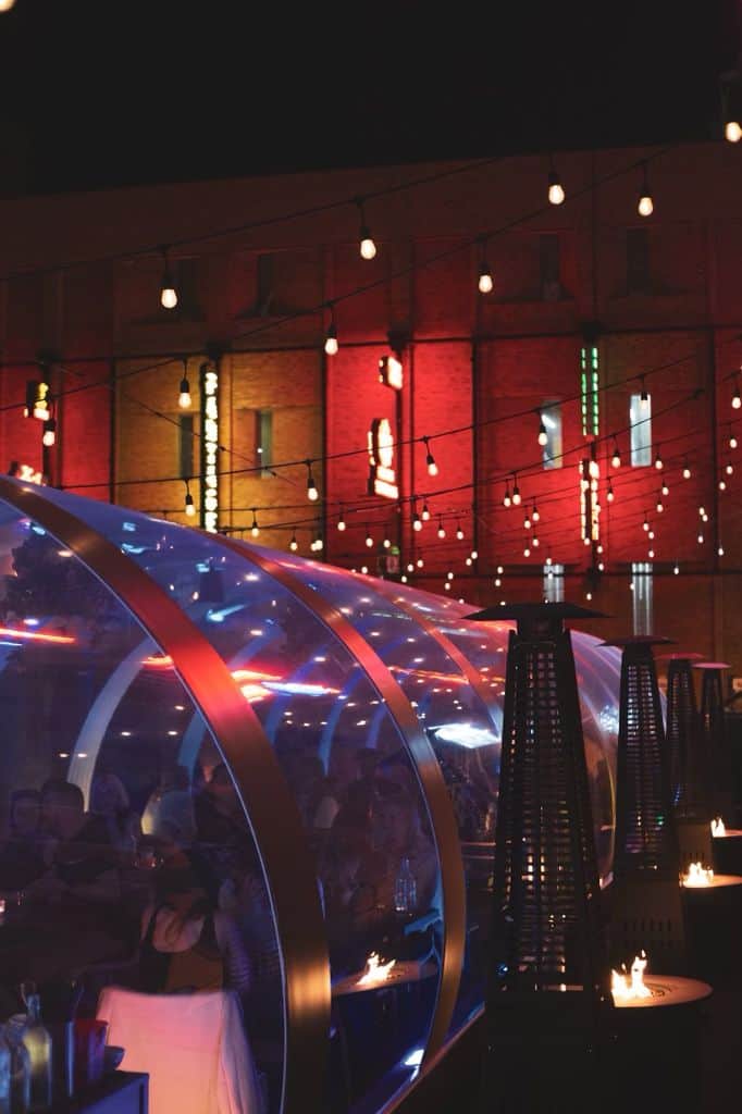 Outdoor patio with stylish lighting, cozy seating, and modern decor at Baijiu, Canada's top spot for outdoor dining and socializing.